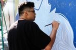 Portland artist Victor Bizar Gomez paints his mural as part of the Portland Street Art Alliance's Mt. Whitney Blocks project.