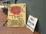 Community members gather outside The Portland Building in southwest Portland to rally against the 10-year Clean and Safe contract renewal, July 27, 2021